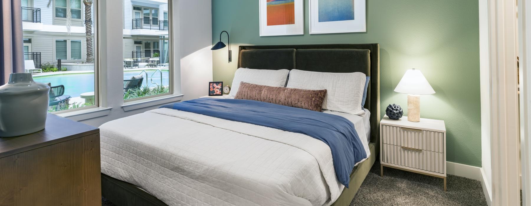 a bedroom with a fan and a bed