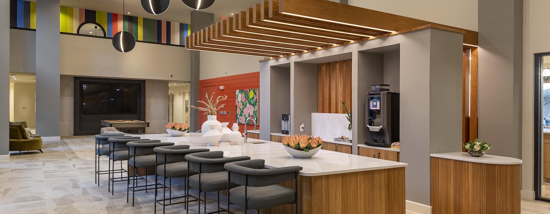 clubhouse kitchen with a bar and chairs